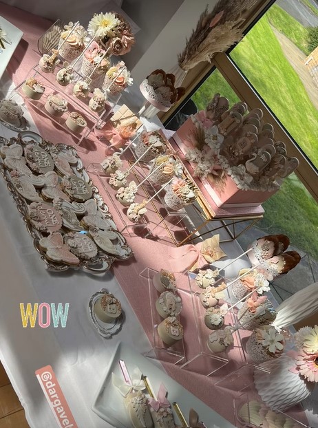 a table with a lot of desserts on it and a sign that says wow