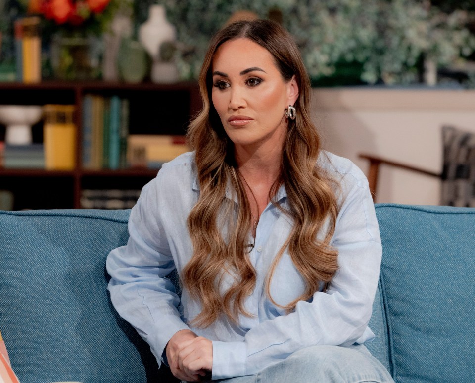 a woman in a blue shirt sits on a blue couch