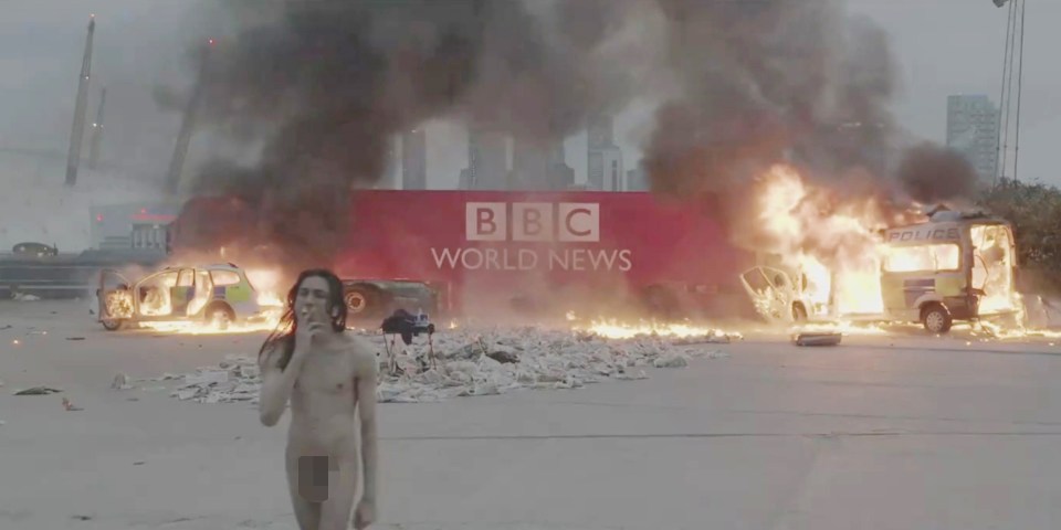 a man standing in front of a bbc world news sign