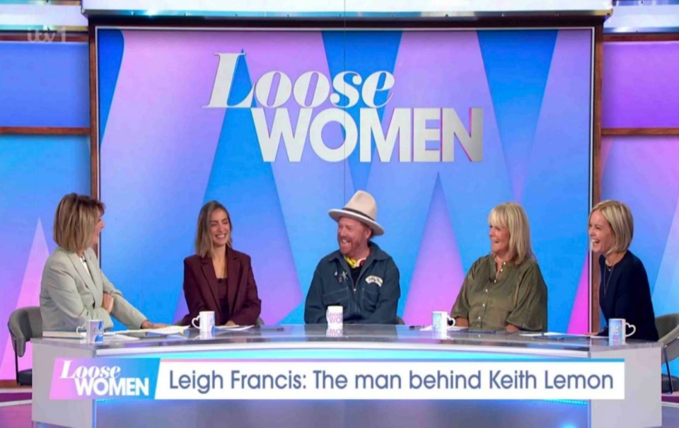 a group of people are sitting at a table on loose women