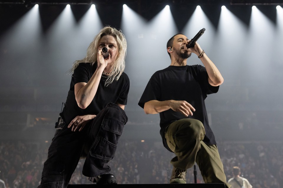 a man and a woman singing into microphones on a stage