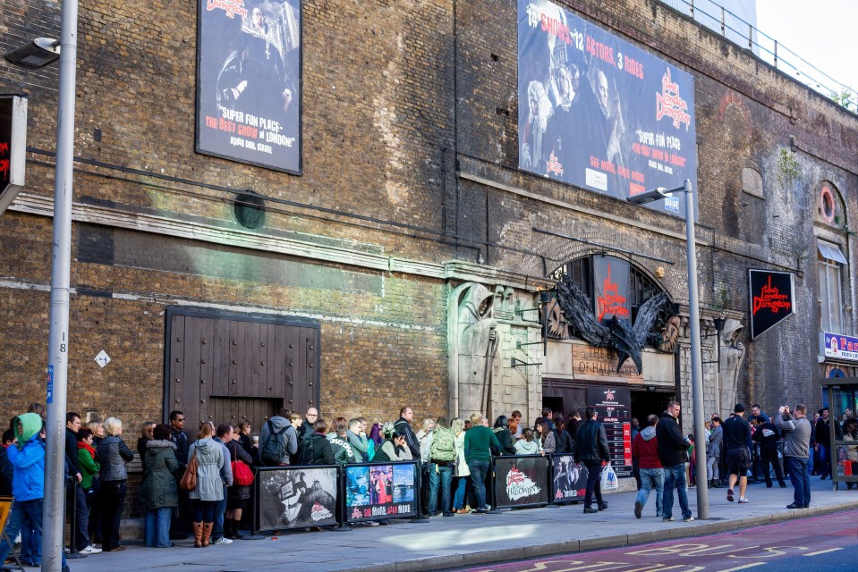 a group of people standing outside of a building with a sign that says ' super fun place ' on it