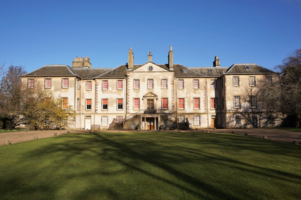 a large building with a blue sky in the background