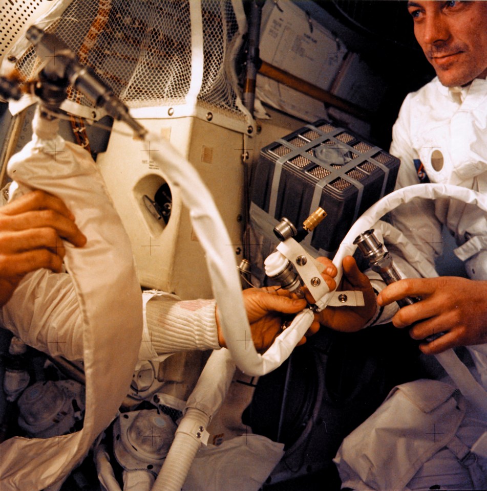 a man in a space suit is working on a device