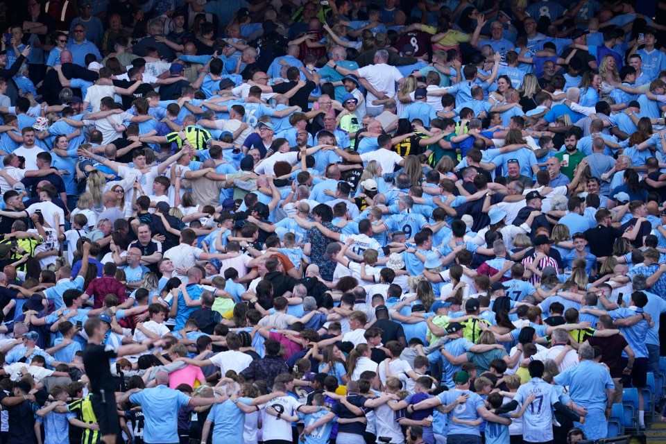 a crowd of people wearing blue shirts including one with the number 17 on it