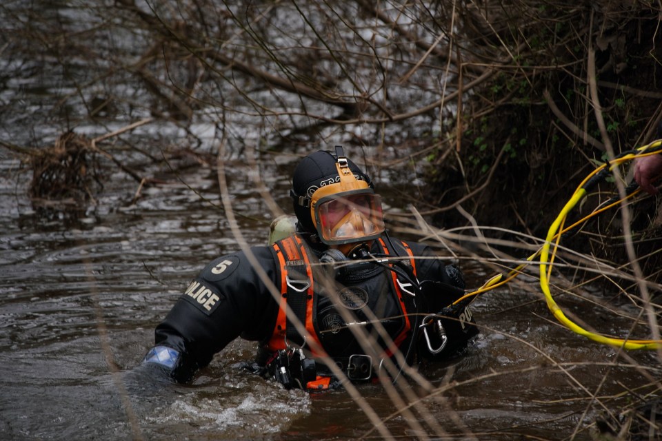 a man in a police uniform is swimming in the water