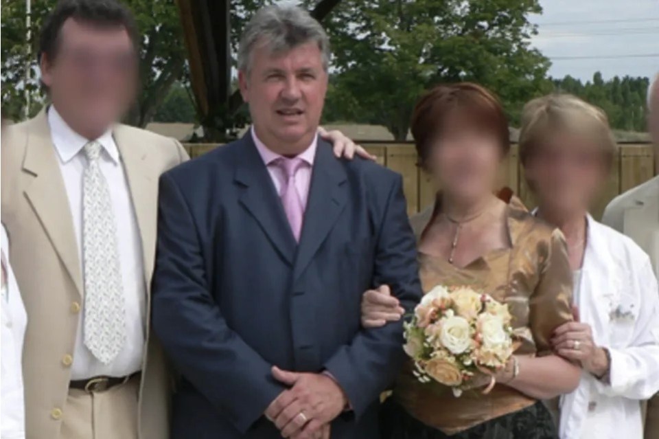 a man in a suit and tie poses with a woman holding a bouquet of flowers