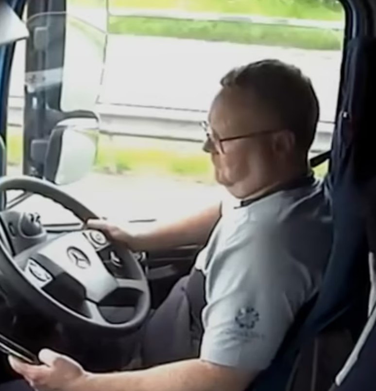 Footage captures Raymond looking at his phone as he drives along