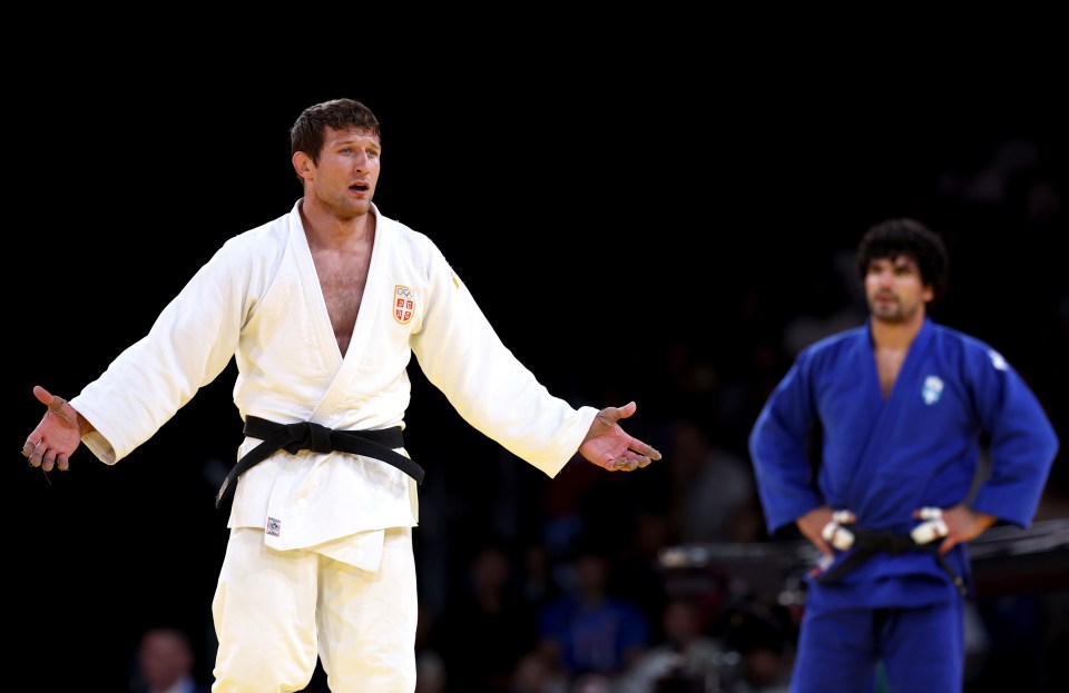 a man in a white kimono with the word england on it