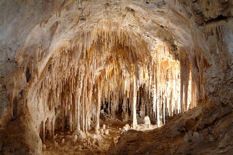 a cave with a lot of icicles hanging from the ceiling