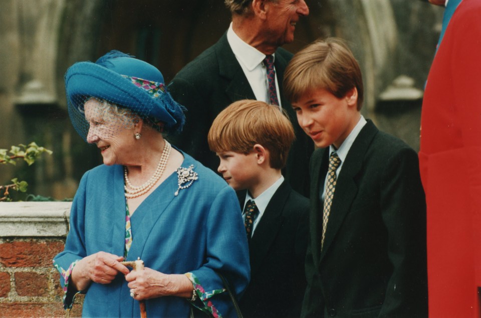 a woman in a blue hat stands next to a boy in a suit