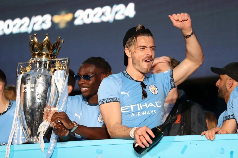 a man in an etihad airways shirt holds a trophy