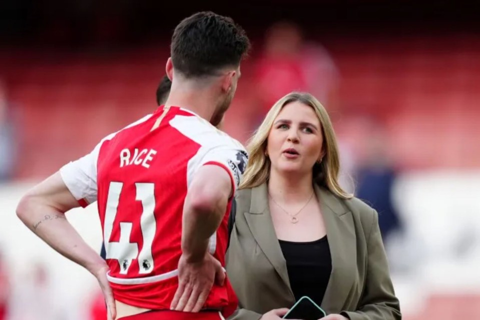 a woman talks to a soccer player wearing the number 43