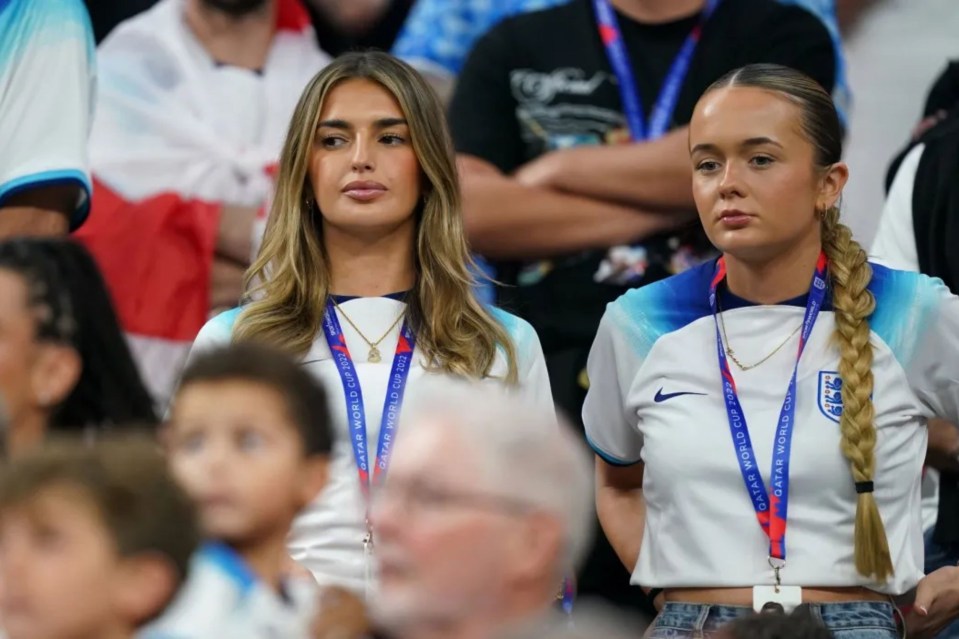 two women wearing lanyards that say fifa world cup