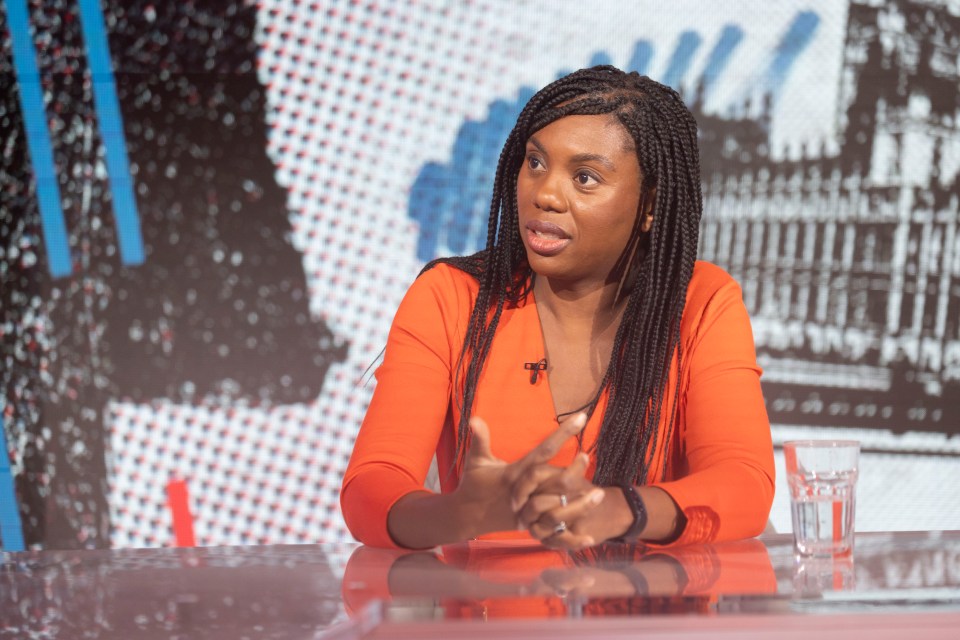 a woman sitting at a table with a glass of water