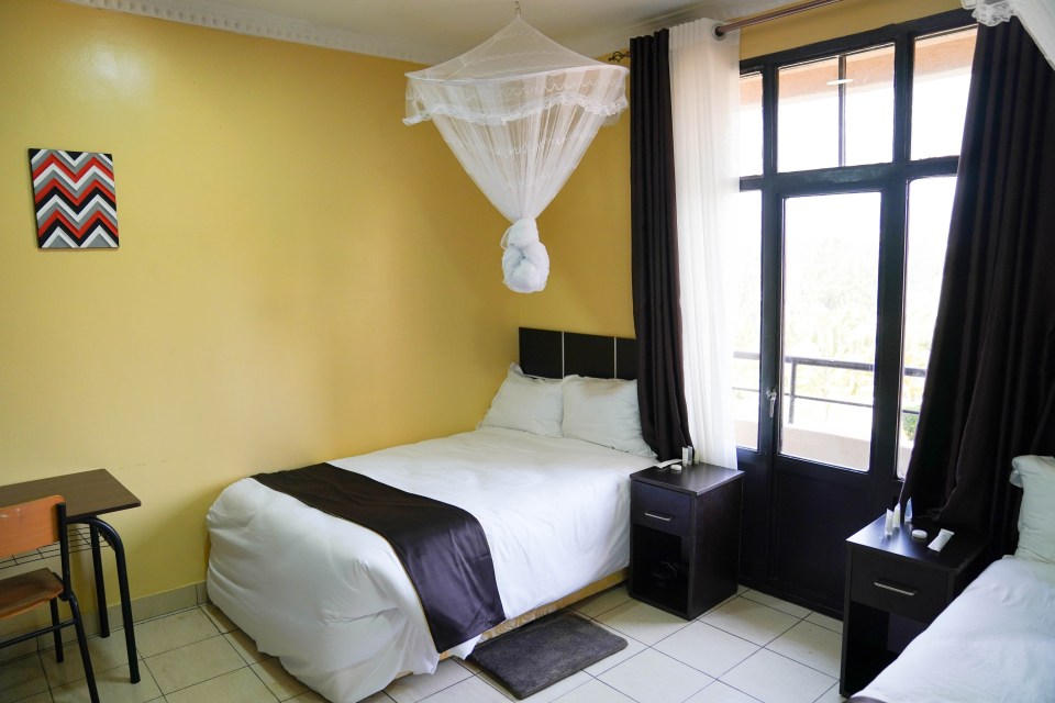 a bedroom with a mosquito net hanging from the ceiling