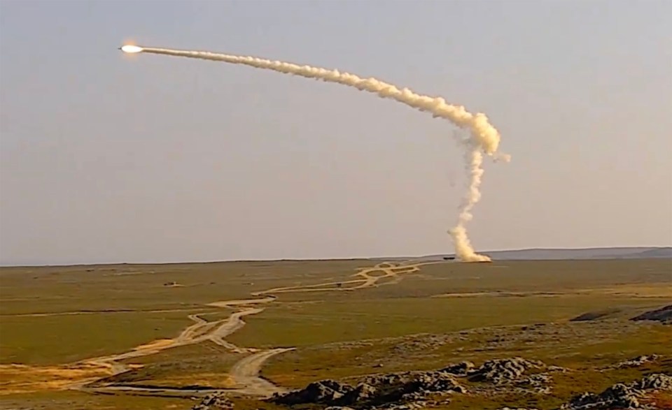 a rocket is being launched into the sky with smoke coming out of it