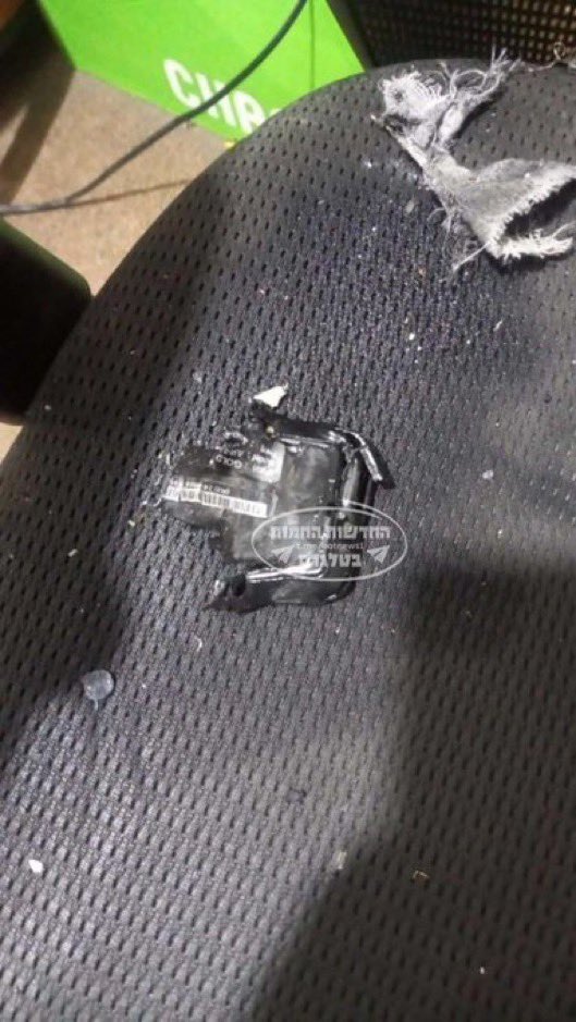 a broken cell phone battery is on a black chair