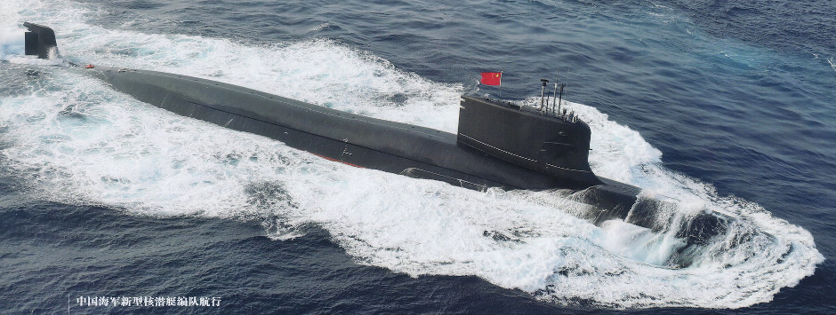 a submarine with a red flag on top is floating in the ocean