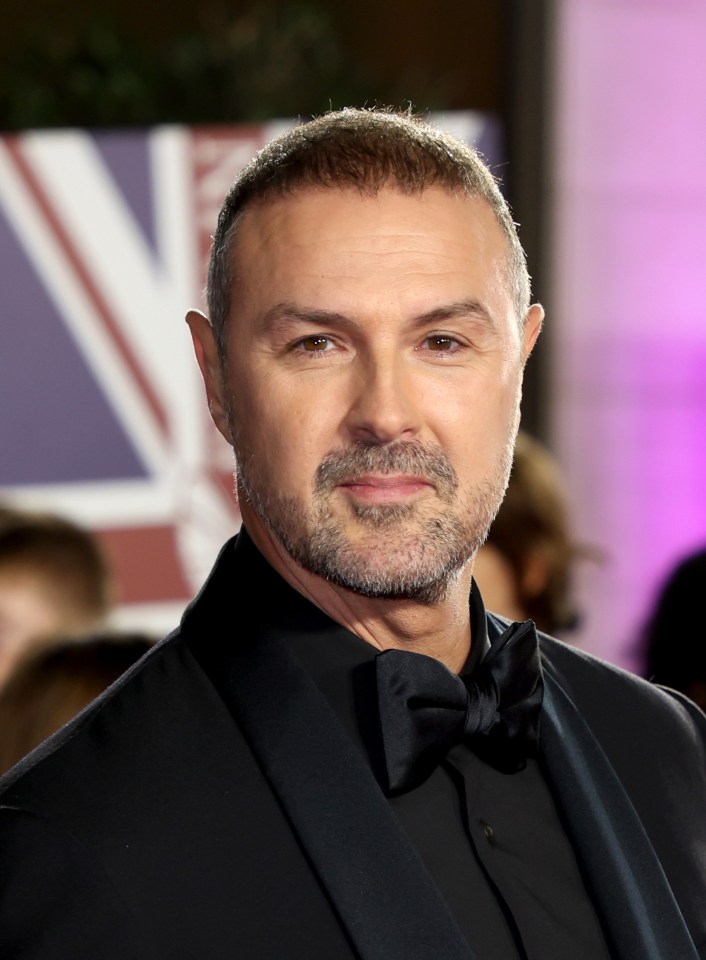 a man with a beard wearing a black tuxedo and bow tie