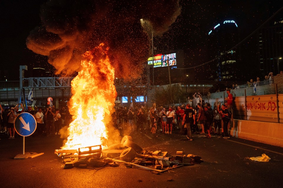 A fire rages in Tel Aviv during anti-government protests on Sunday