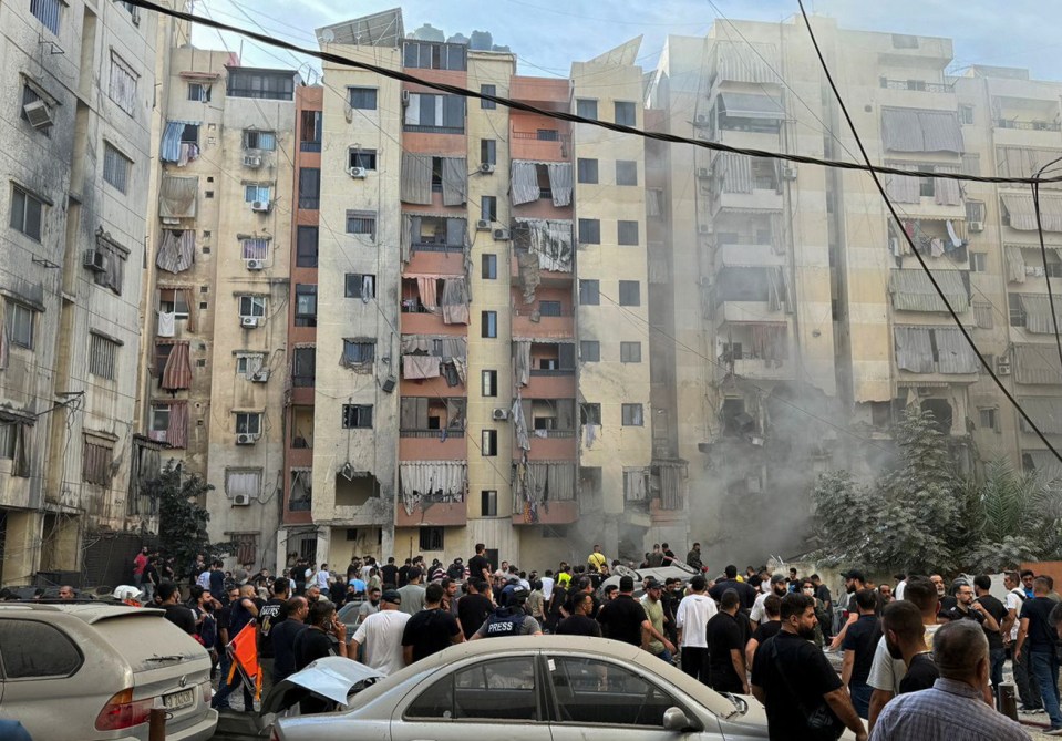 People inspect the site of an Israeli strike in the southern suburbs of Beirut, Lebanon