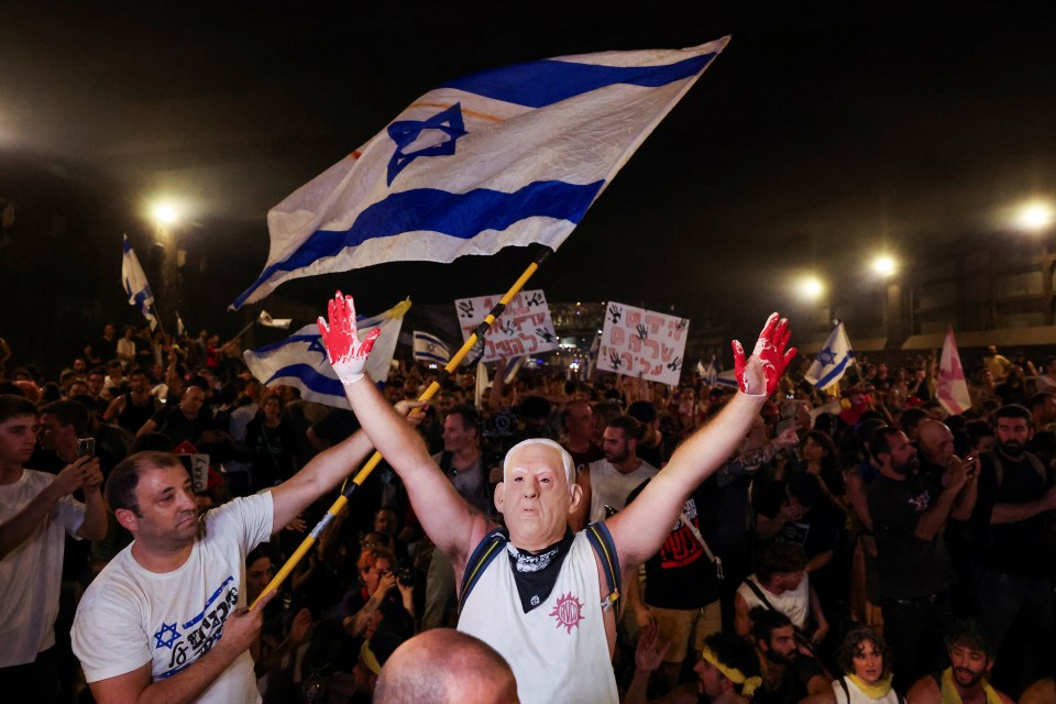 People carried placards of a blood-soaked Netanyahu after the hostages were shot by Hamas in country-wide protests