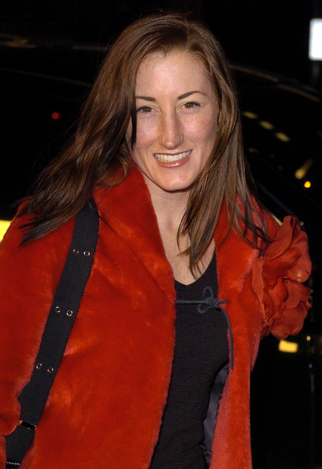 a woman wearing a red fur coat smiles for the camera