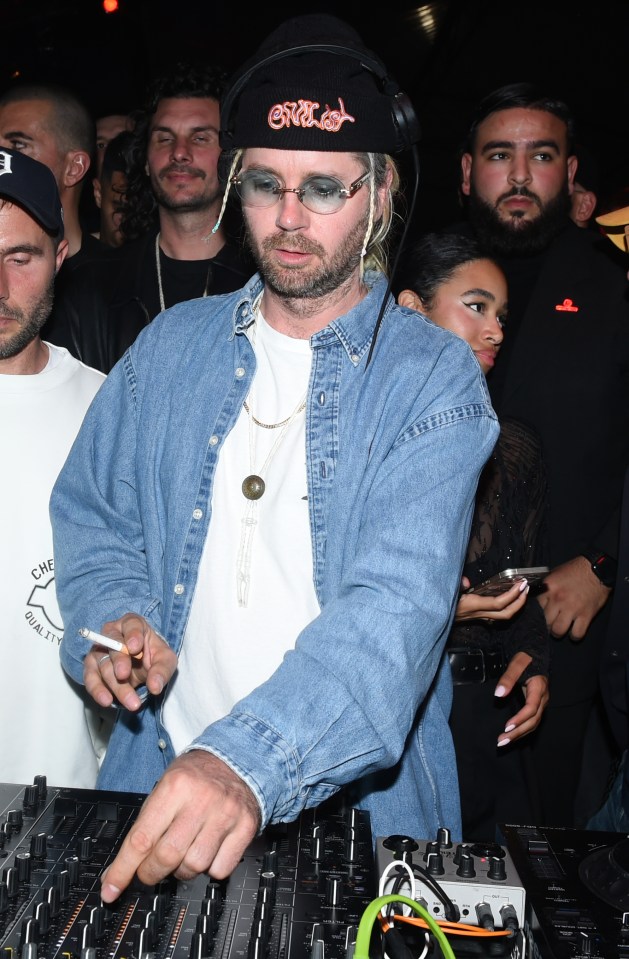 a man wearing headphones and a hat that says crooked