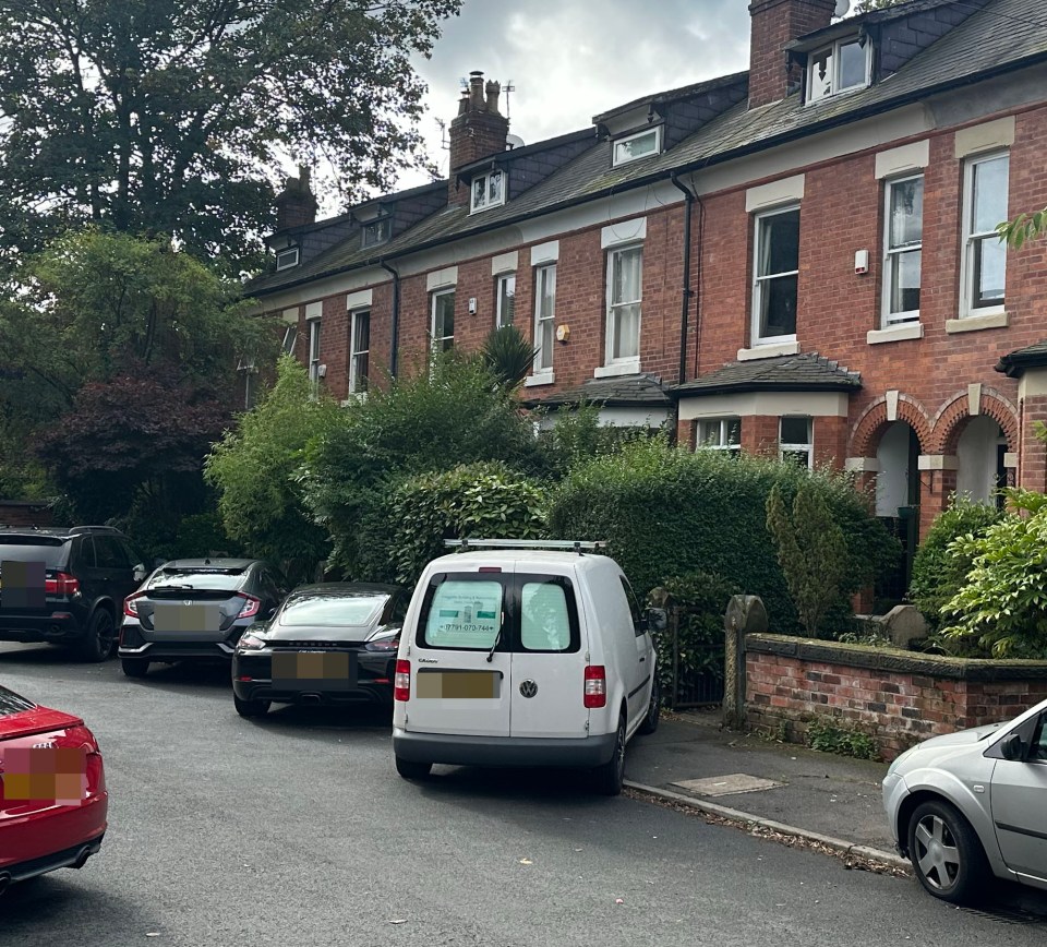 a white van is parked in front of a row of brick houses