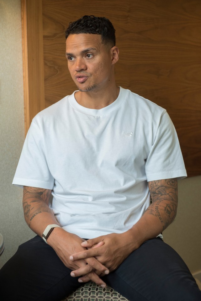 a man wearing a white t-shirt with the word reebok on it