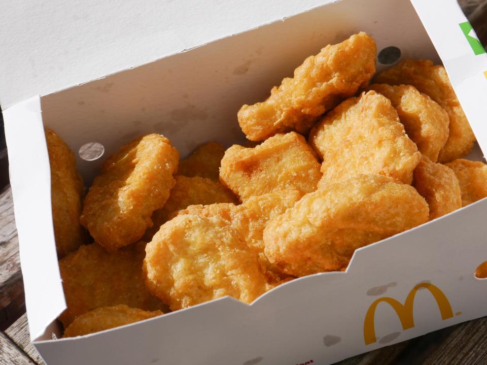 a box of mcdonald 's chicken nuggets sits on a wooden table