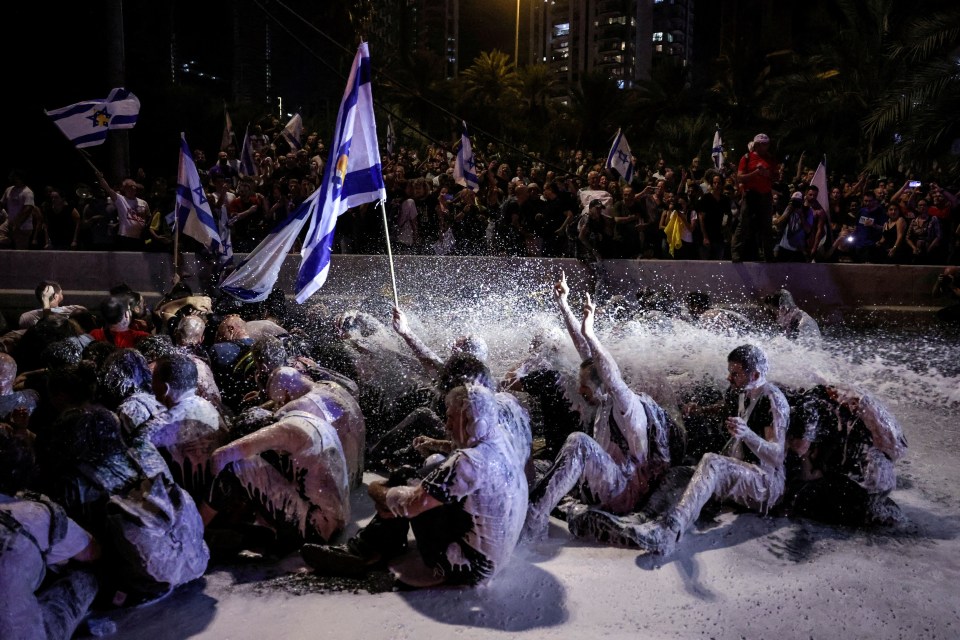 Police in Tel Aviv sprayed protestors sitting in the middle of a road with a water cannon on Sunday