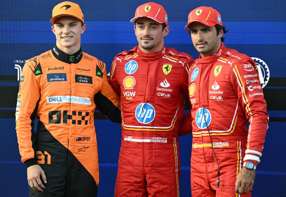 three racing drivers are posing for a picture and one of their sponsors is dell