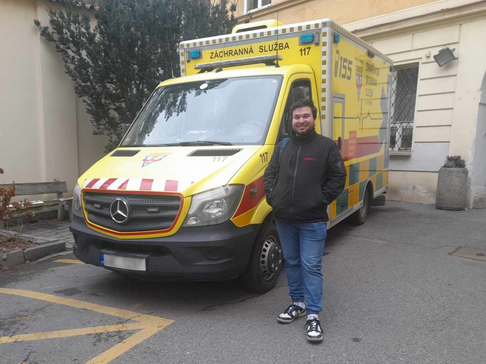 a man stands in front of an ambulance with the number 117 on it