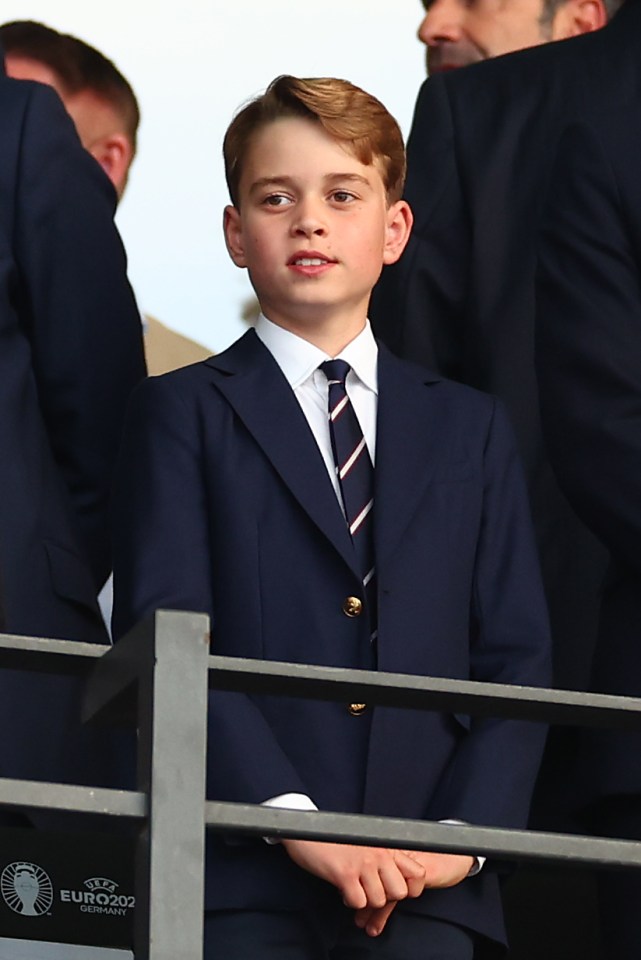 a boy in a suit sits in front of a sign that says euro2002