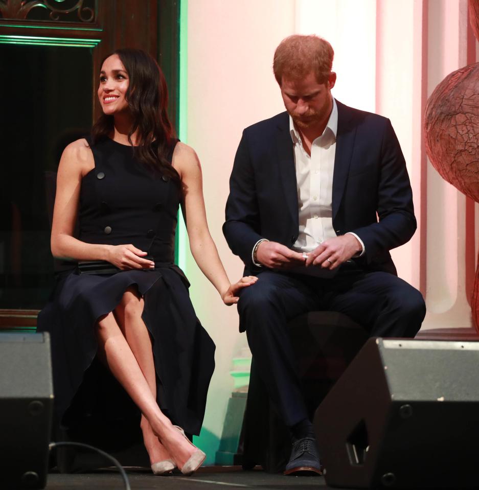 We often see the duchess with her hand resting tenderly on Harry's knee