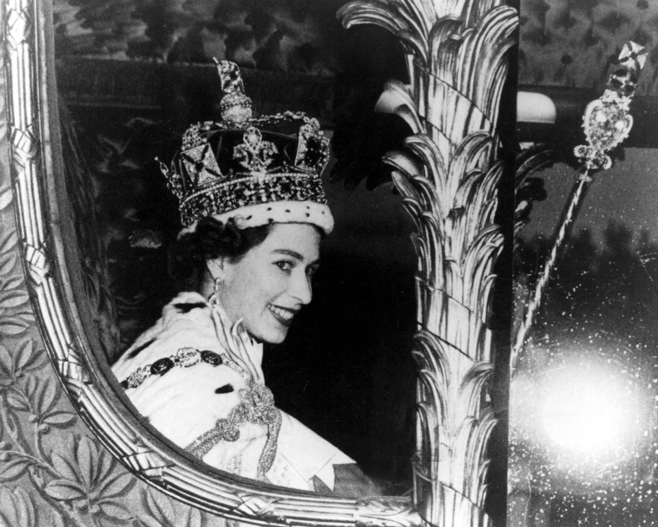 The new queen beams from the Gold State Coach during the procession back to Buckingham Palace on her Coronation Day, June 2, 1953