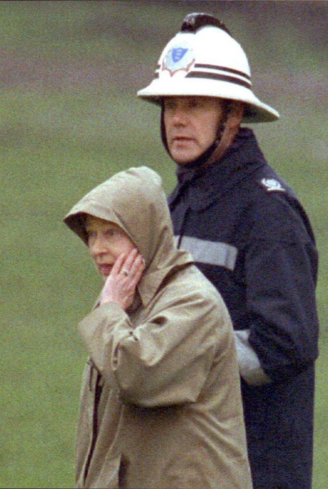 The Queen is escorted to safety as Windsor Castle burns