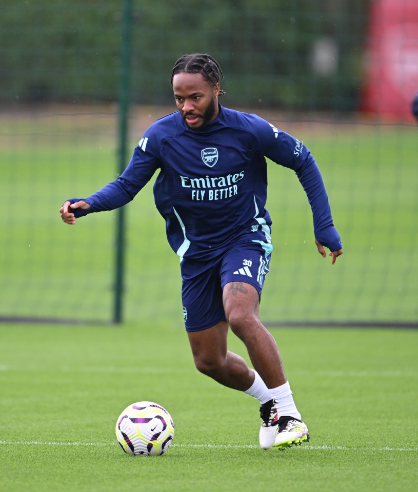 a soccer player wearing a shirt that says emirates fly better