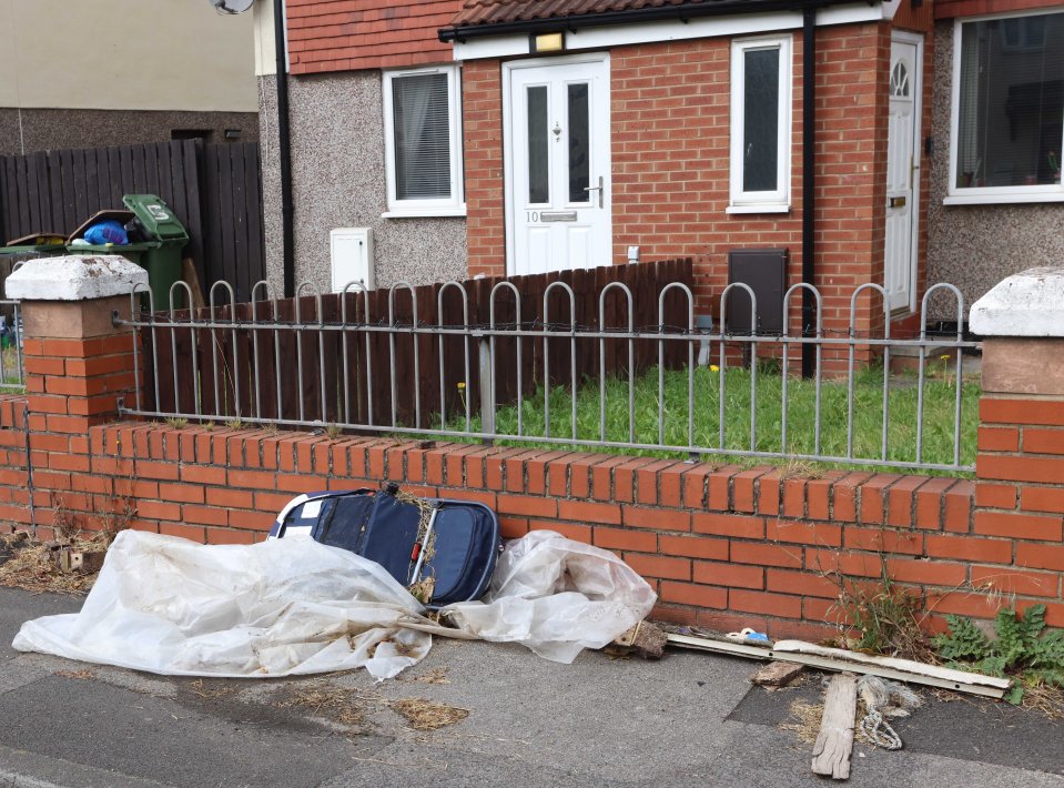 Wood, plastic and an old pram dumped in front of one family's home