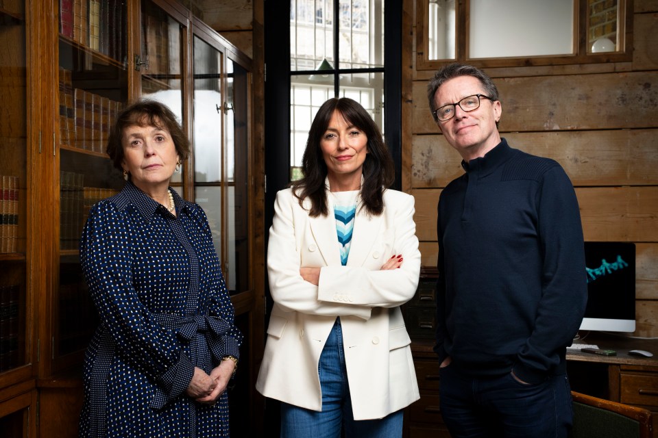 a man and two women standing next to each other with their arms crossed