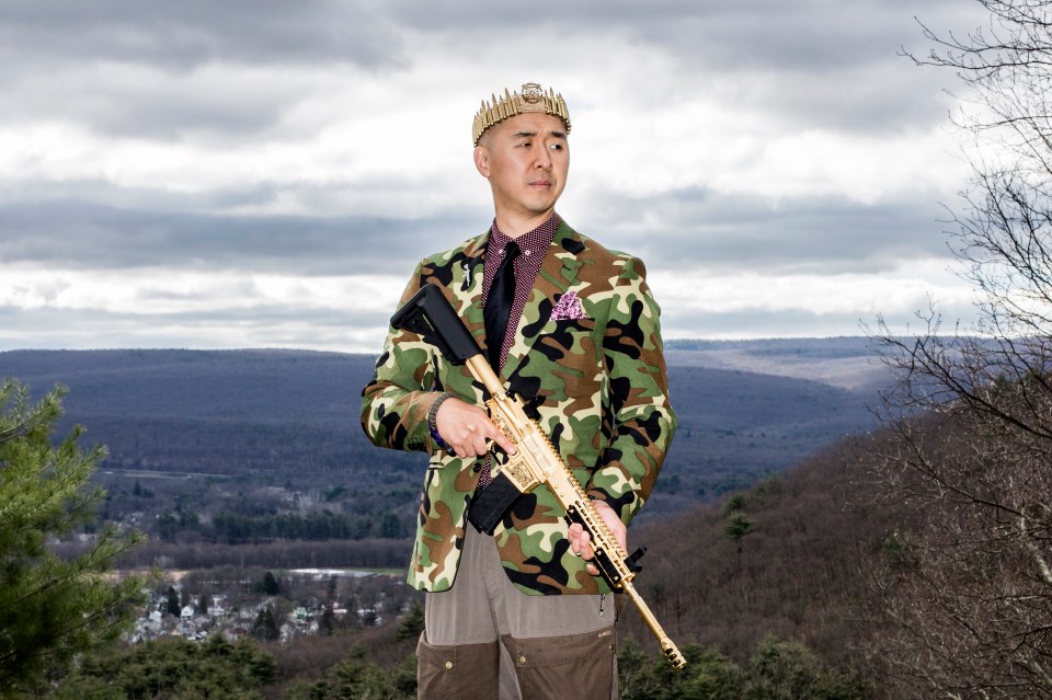 Reverend Hyung Jin “Sean” Moon - the son of the Unification Church's founder - poses with his gold AR-15 “rod of iron”