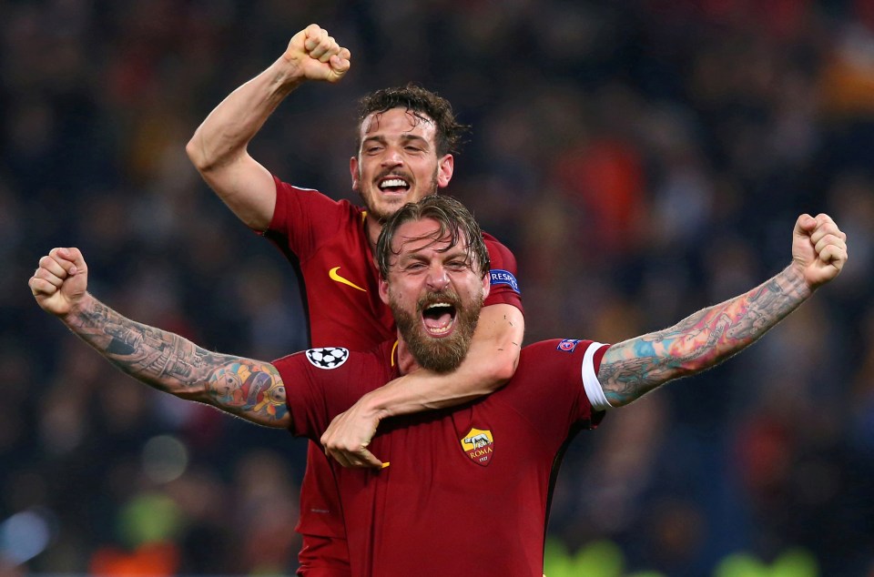 two soccer players are celebrating with their arms in the air