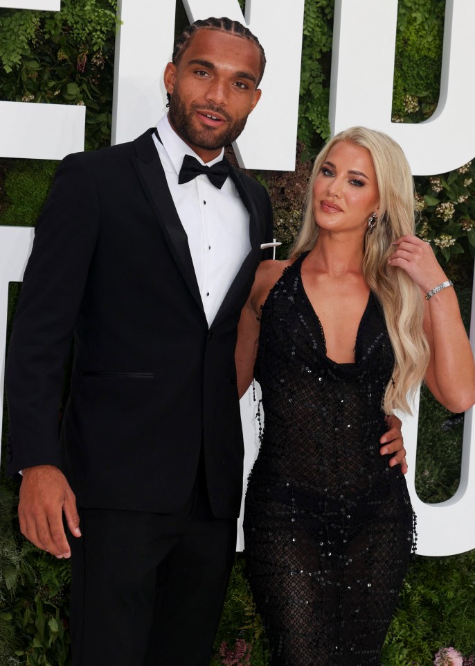 a man in a tuxedo stands next to a woman in a black dress