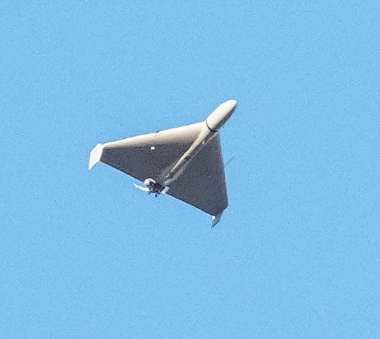 a small plane is flying through a blue sky