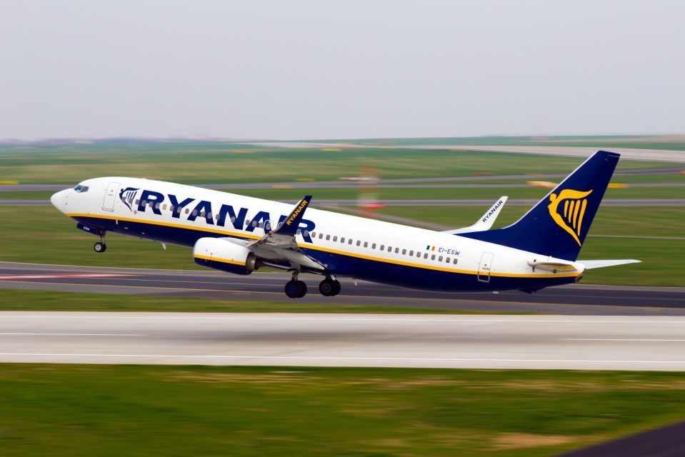 a ryanair plane is taking off from a runway