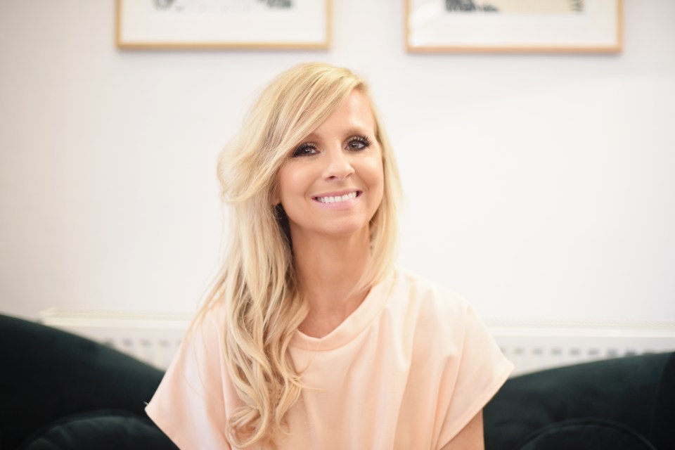 a woman with blonde hair is smiling for the camera