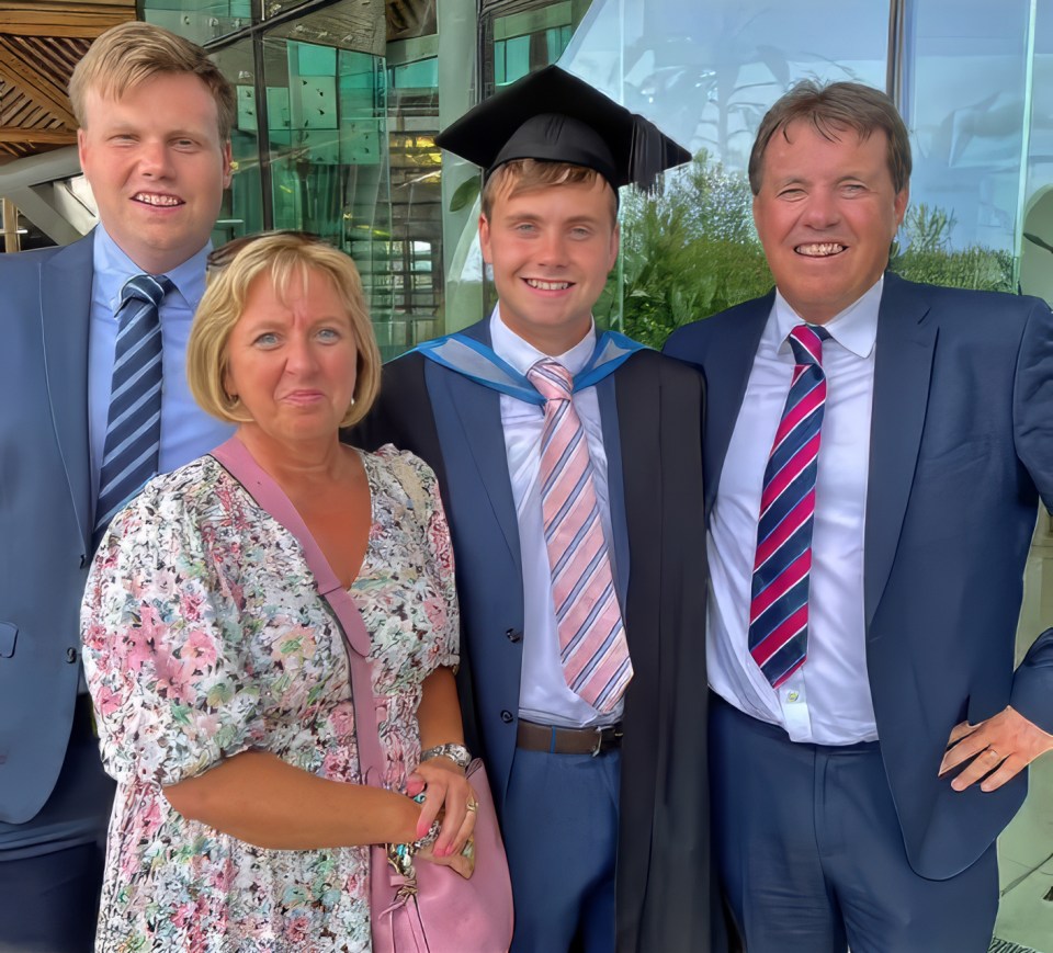 a man in a graduation cap and gown poses with his family