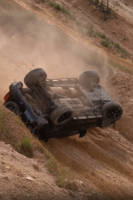 The overturned car off the edge of the quarry